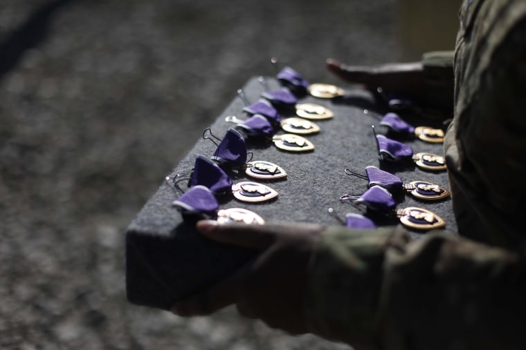 Image: A military aide holds Purple Heart medals that U.S. Sec. of Defense Leon Panetta will award during his visit to the 172nd Infantry Brigade Task Force Blackhawks at a forward operating base in Sharana, Afghanistan