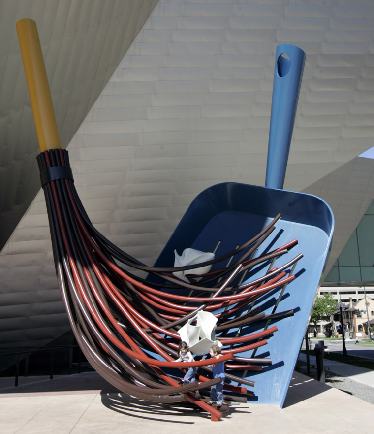 ** FILE** In this May 24, 2007 file photo Phoebe and Joel Mackler are dwarfed by the size of a sculpture of a broom and dustpan at the Denver Art Museum in downtown Denver. The first Saturday of every month admission to the art musem is free. (AP Photo/Ed Andrieski, File)