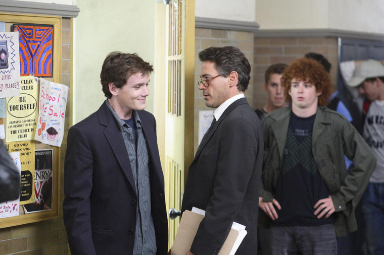 Charlie Bartlett - 2008 
A rich kid (Yelchin) becomes the self-appointed psychiatrist to the student body of his new high school
(L-R) Charlie Bartlett (Anton Yelchin) encounters Principal Gardner (Robert Downey Jr.) as he takes a break from his counseling sessions in the boy's bathroom