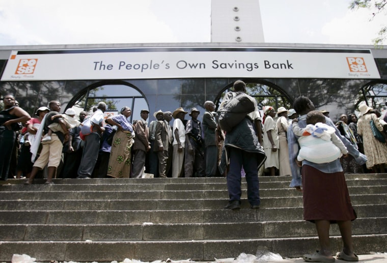 People queue to withdraw money from the POSB in central Harare