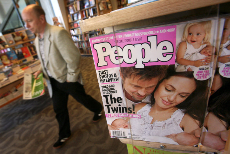 A man walks past a magazine rack showing a  People Magazine featuring photos of Angelina Jolie and Brad Pitt's newborn twins at a bookstore on Monday, Aug. 4, 2008, in San Francisco. (AP Photo/Jeff Chiu)
