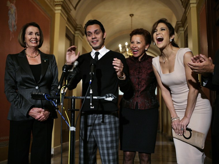 Image: Singer Anthony and actress Lopez speaks to reporters before meeting with Pelosi in Washington