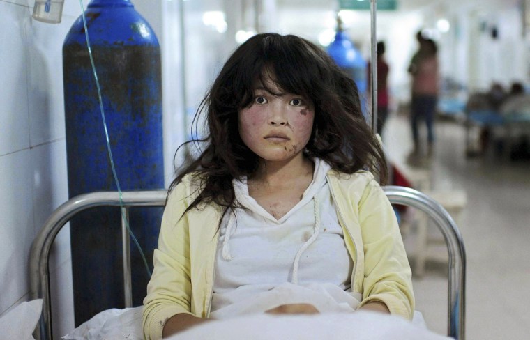Image: An injured woman receives treatment at a hospital after a 6.6 magnitude earthquake hit Minxian county, Dingxi