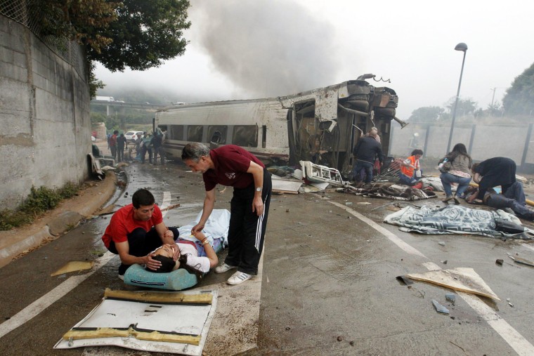Image: Victims receive help after a train crashed near Santiago de Compostela