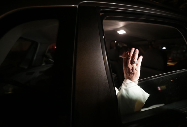 Image: Pope Francis waves as he leaves Guanabara Palace where he attended a welcoming ceremony in Rio de Janeiro