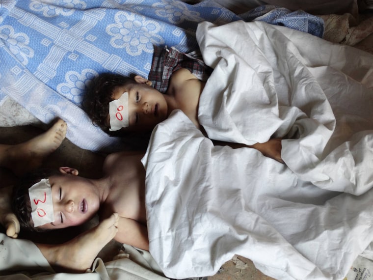 Image: A view shows  bodies of children activists say were killed by nerve gas in the Ghouta region, in the Duma neighbourhood of Damascus