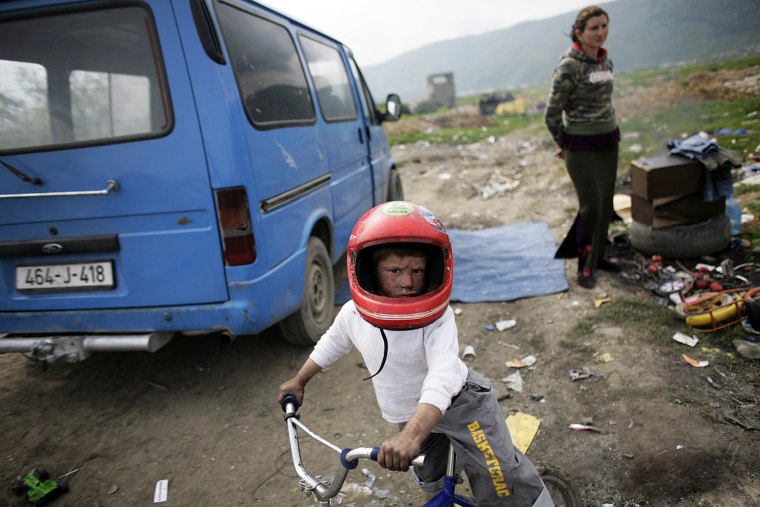 Roma boy wears a helmet on St. George's Day or Djurdjevdan in the Roma settlement in Sarajevo's suburb of Butmir