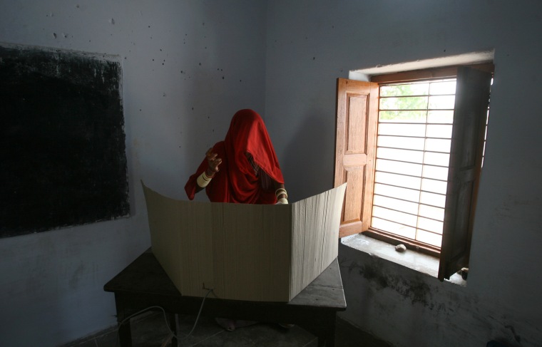 A woman casts her vote at a polling centre during the fourth phase of India's general elections in Ore Village near Abu Road