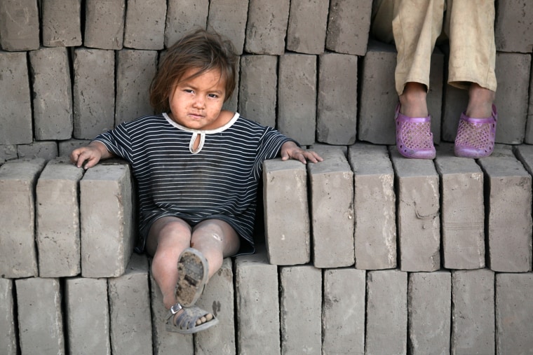Image: A daughter of a worker rests at a brick factory in La Paz Centro