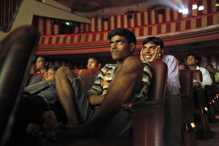 Image: Cinema goers watch a Bollywood movie that has set a record of 770 weeks of screening in Mumbai