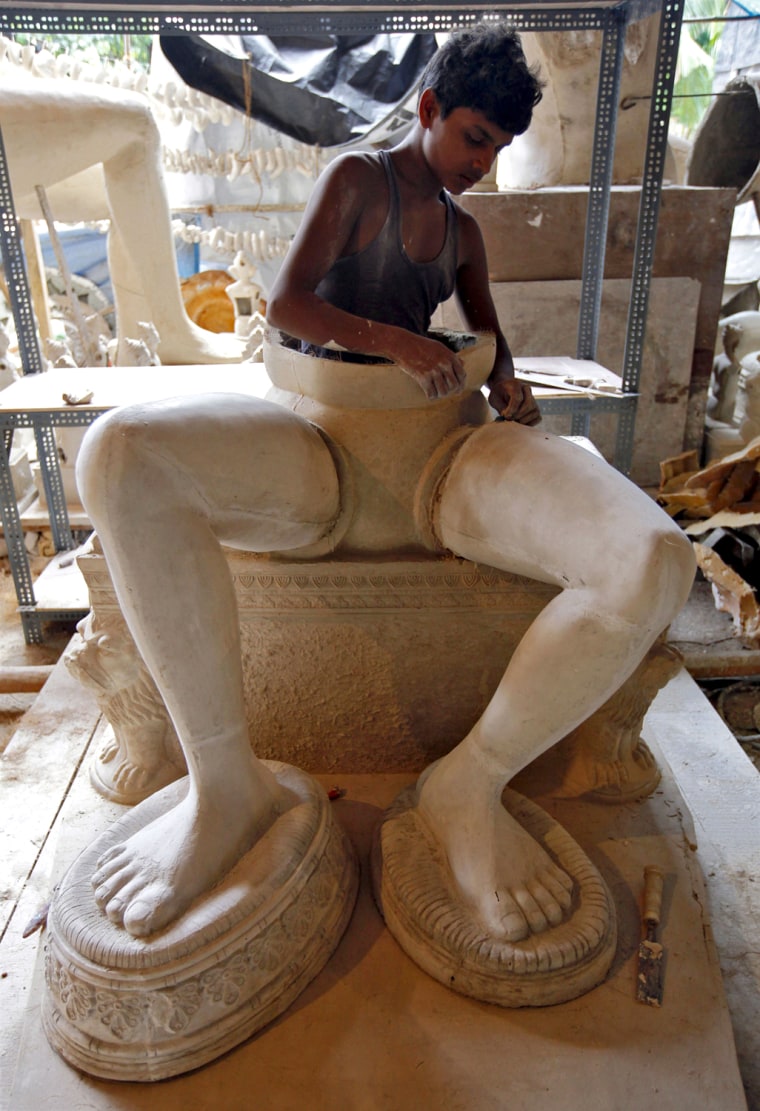 Image: An artisan makes an idol of Hindu elephant god Ganesh in Mumbai