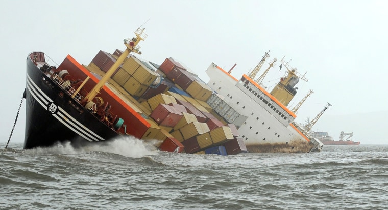 Image: Containers fall from the deck of the damaged cargo ship MSC Chitrain in the Arabian Sea