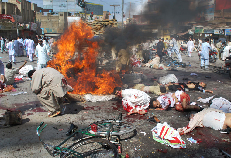 Image: Injured men and dead bodies are seen at the site of a suicide attack in Quetta
