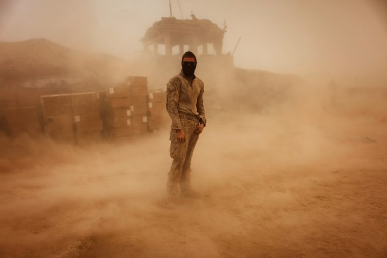 Image: PFC. Voris stands during a sandstorm in southern Afghanistan's Helmand province