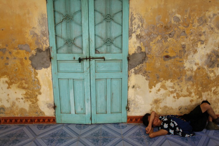 Image: A female leper rests in the isolated village of Van Mon, south of Hanoi
