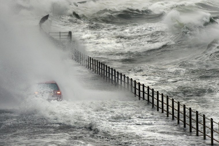 Image: A Volkswagen is engulfed by water on Nov. 11, in Salcoats, Scotland