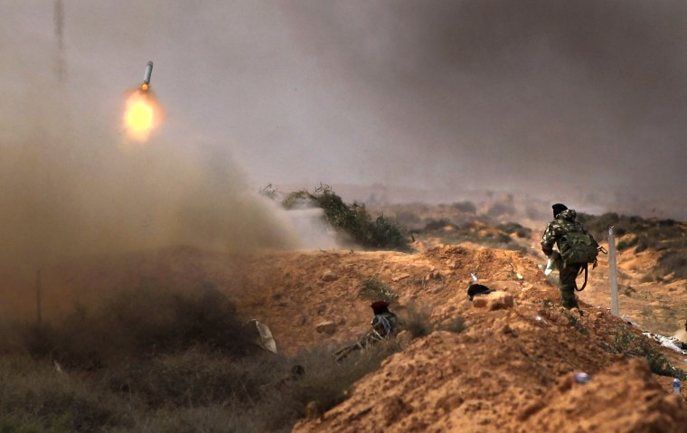 Image: Libyan rebels fire rockets at government troops from the frontline