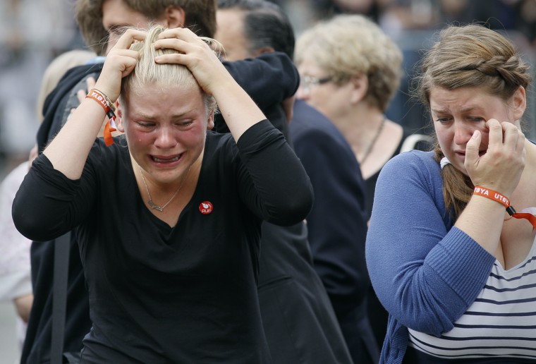 Image: Survivors and relatives of a shooting rampage on the Utoeya island mourn following a memorial service in Oslo cathedral