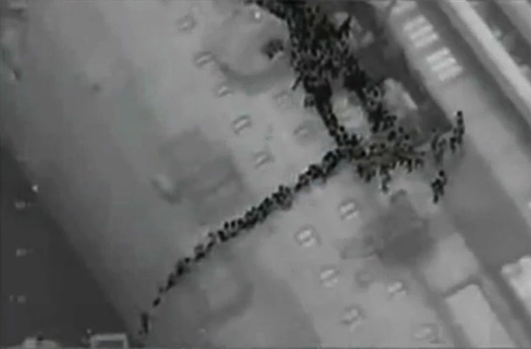 Image: Video grab shows passengers lined up on the side of the Costa Concordia during the evacuation operation