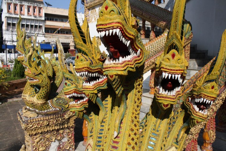 While on our honeymoon in Chiang Mai, Thailand, my wife and I visited numerous Wats (Buddhist Temples). Guarding the entrance of every Wat was a pair of Dragons, like these.