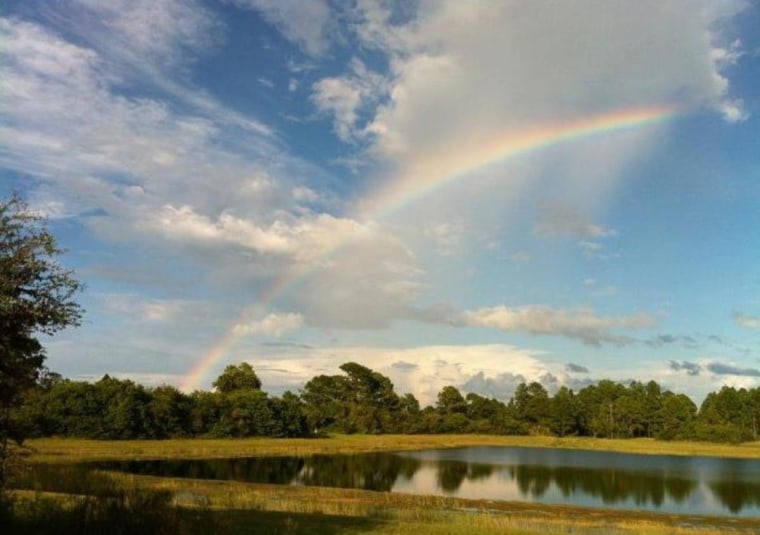 View of a rainbow over the pond behind my sons house
