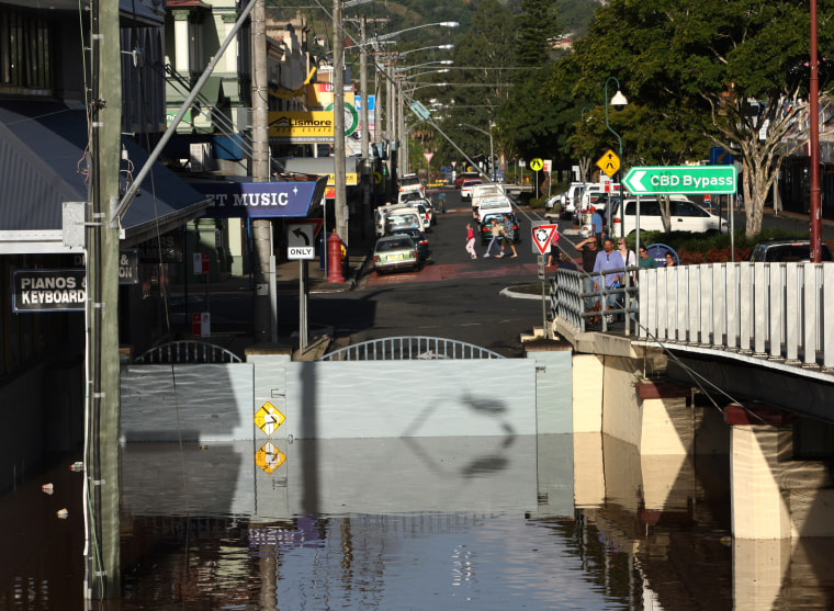 Floodwaters are held back by a section of the levee in Lismore, Australia, on Friday. Some 5,000 people in the city were ordered to evacuate Friday. 