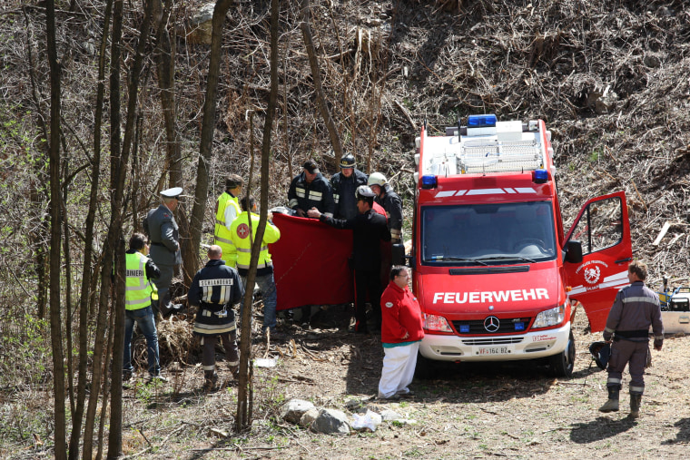 Rescuers work at the scene of a train derailment near Merano, Italy, in which 9 people were killed.