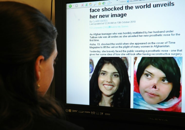 Image: A journalist reads an online story about