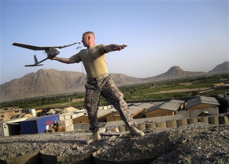 Pfc. Joseph Robinson, 20, of Eugene, Oregon, launches a 'Raven', an unmanned reconnaissance drone, at Combat Outpost Senjeray, Kandahar province, Afghanistan, on Sept. 11.
