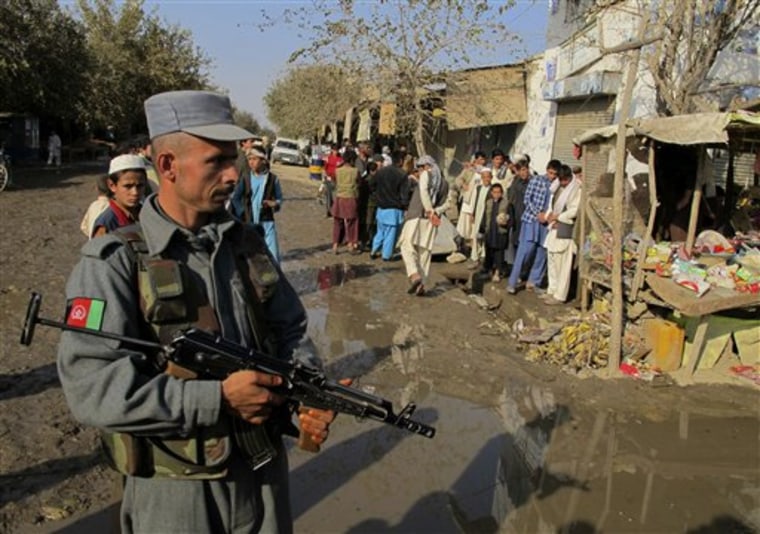 An Afghan police officer stands guard near the site of an explosion in Kunduz, Afghanistan, on Saturday.