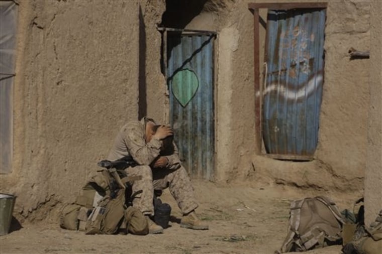 A U.S. Marine from 3rd Battalion, 6th Marine Regiment sits alone after a patrol in Marjah in Afghanistan's Helmand province Friday, Feb. 19, 2010. (AP Photo/David Guttenfelder)
