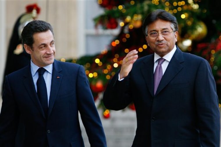 Pakistani President Pervez Musharraf, right,  arrives for talks with French President Nicolas Sarkozy, left, at the Elysee palace on Tuesday in Paris. Musharraf is on a eight-day European tour. 