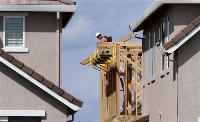 A construction worker is seen at a home being built April 5 in Sacramento, Calif. The rise in the Conference Board's index of leading economic indictors suggests economic growth is likely to continue for the next three to six months. 