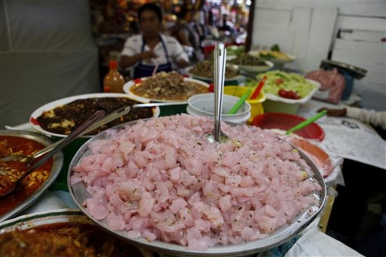 This photo taken June 4, 2010 shows \"pata,\" made of chopped up pork feet cartilage, displayed among other foods at a market in Mexico City which was included in a 10-day culinary tour of Mexico. The tour is part of Mexico's initiative to promote culinary tourism. (AP Photo/Eduardo Verdugo)