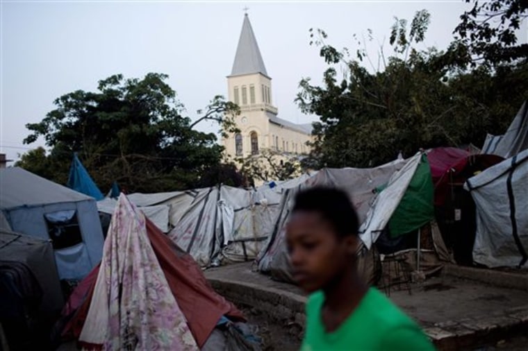 A young girl walks next to tents in a camp for people left homeless during the 2010 earthquake in the eastern suburb of Petionville, Port-au-Prince, Haiti, on Friday Jan. 28. A year after the devastating earthquake that destroyed this city, life is returning to normal but thousands continue living in makeshift camps. 