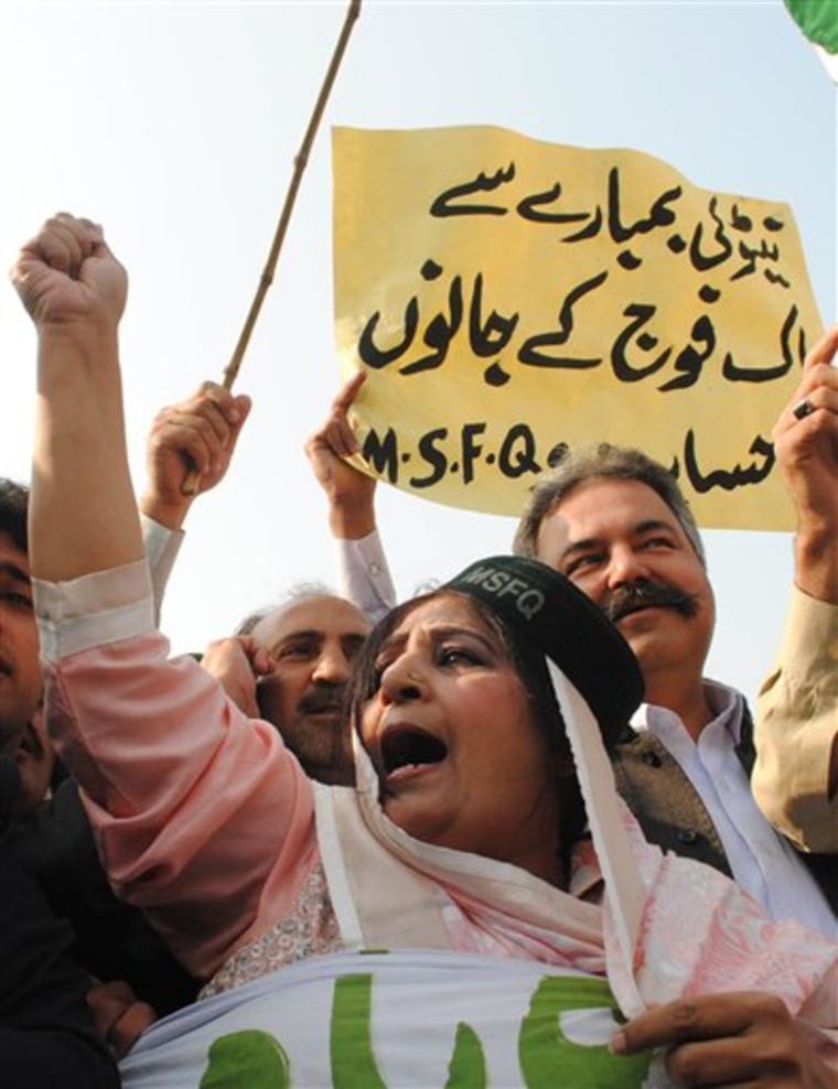 A Pakistani woman joins others to condemn NATO strikes on Pakistani posts, in Peshawar, Pakistan on Monday. The NATO airstrikes that killed 24 Pakistani soldiers went on for almost two hours and continued even after Pakistani commanders had pleaded with coalition forces to stop, the army claimed Monday in charges that could further inflame anger in Pakistan. A placard reads "NATO is responsible for the loss of Pakistani soldiers."