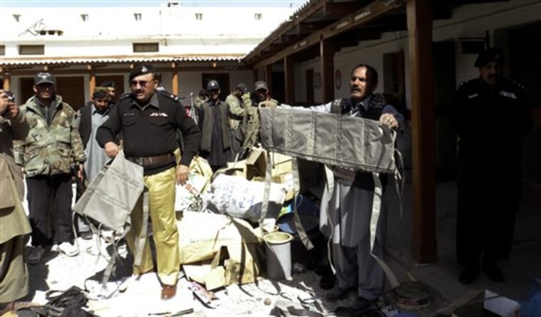 Pakistani police officers show explosive jackets they confiscated during a raid at a house in Chaman, a Pakistani border town along Afghanistan border on Wednesday, Feb. 17. 