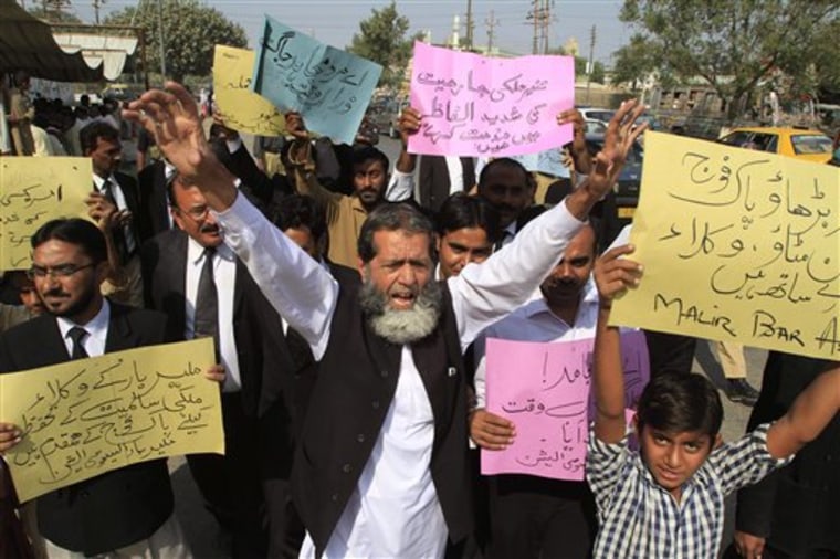 Pakistani lawyers rally to condemn NATO strikes on Pakistani troops, in Karachi, Pakistan, on Monday, Nov 28, 2011.  The NATO airstrikes that killed 24 Pakistani soldiers went on for almost two hours and continued even after Pakistani commanders had pleaded with coalition forces to stop, the army claimed Monday in charges that could further inflame anger in Pakistan. Placard on right reads \" Go ahead Pakistan army we are with you.\"(AP Photo/Shakil Adil)