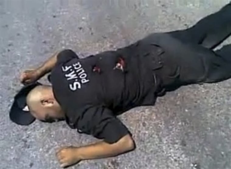 This undated amateur video image posted on the internet and shown on Syrian state television shows a Syrian policeman lying on the ground apparently dead from gunshot wounds in Jisr al-Shughour, northern Syria. Residents fled a northern region on Tuesday June 7, 2011 where authorities said weekend clashes between armed men and government troops killed 120 security forces, fearing retaliation from a regime known for ruthlessly crushing dissent. Syria's government said \"armed gangs\" killed 120 security forces in an ambush but did not explain how the heavily armed military could suffer such an enormous loss of life. Jisr al-Shughour has been the latest focus of Syria's military, whose nationwide crackdown on the revolt against President Bashar Assad has left more than 1,300 Syrians dead, activists say.  (AP Photo/Amateur Video)  UNDATED AMATEUR VIDEO IMAGE POSTED ON THE INTERNET AND SHOWN OF SYRIAN STATE TELEVISION - AP CANNOT  INDEPENDENTLY VERIFY THE LOCATION, DATE OR AUTHENTICITY OF THIS VIDEO
