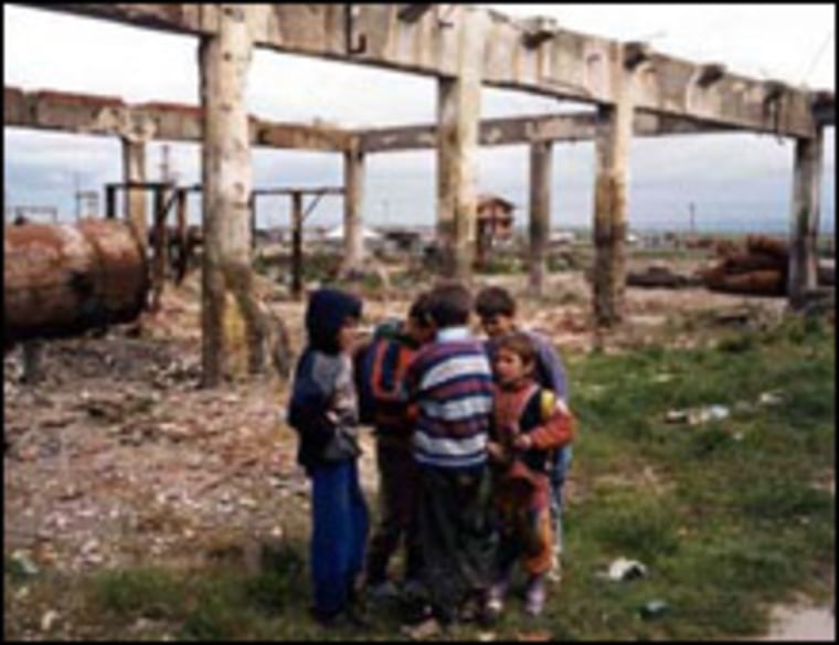 Albanian children play on the contaminated grounds of an abandoned factory in the town of Durres.
