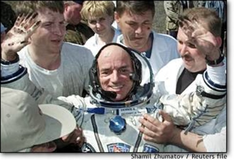 The world's first paying space passenger, Dennis Tito, gestures after landing in Kazakhstan on May 6, 2001. 