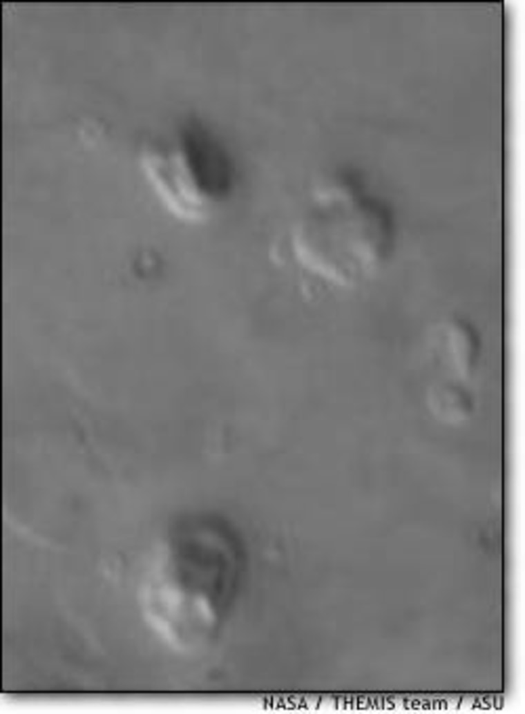 The Face on Mars is the uppermost feature in this infrared image from the Mars Odyssey probe. The image resolution isn't as sharp as earlier pictures of the Face.