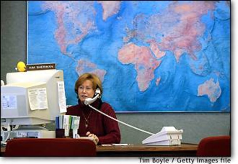 Travel consultant Kim Sherwan speaks with a client on the phone while seated at her desk at First-Maine Travel Agency in Des Plaines, Ill. earlier this year. Travel consultants have been pressured by rising consumer use of Web sites to book trips, as well as airlines who now refuse to pay agent commissions.