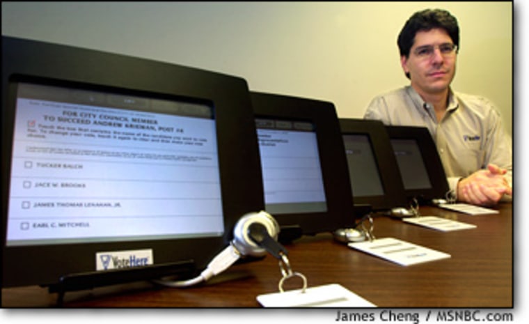In a 2002 photo, VoteHere President Jim Adler shows how his company's system could be used on touch-screen terminals.
