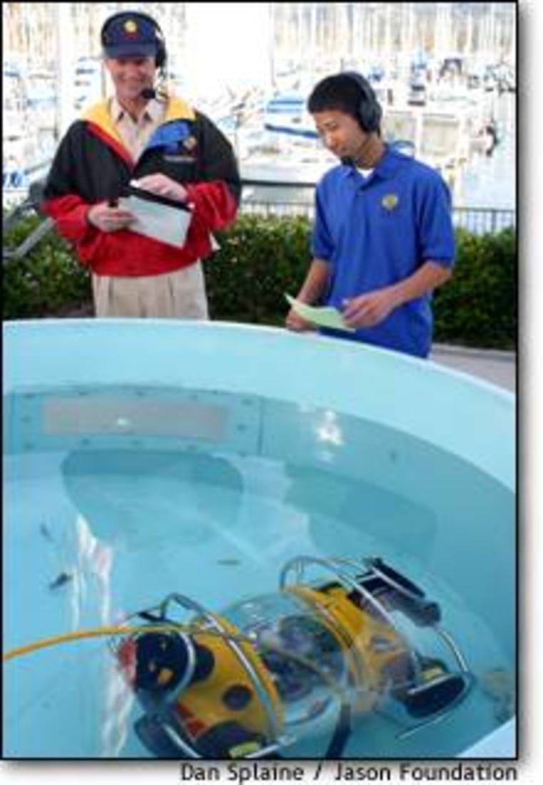 Marine explorer Robert Ballard and student co-host Ben Hovland go over their notes for a Jason Project broadcast from Santa Barbara, Calif., with a model rover in the foreground pool. Ballard says he wants to turn educational expeditions like the Jason Project into a year-round adventure.