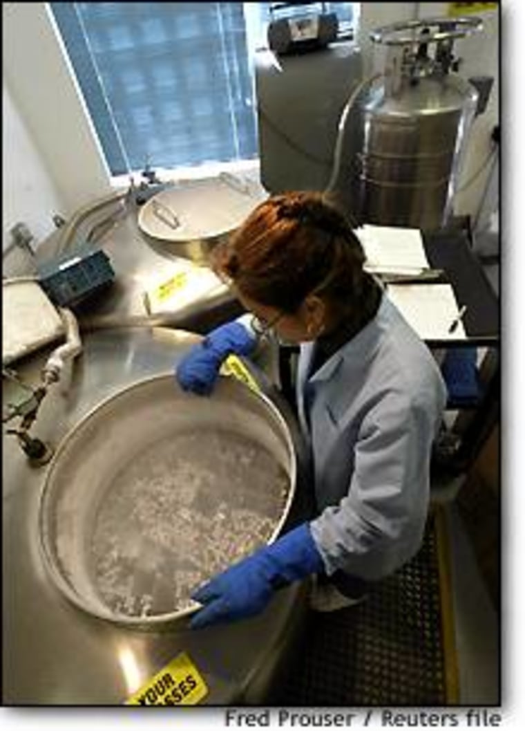 Merlyn Block, assistant supervisor of cryogenics at California Cryobank, Inc., arranges sperm samples in a tank of liquid nitrogen at the company's headquarters in Los Angeles on Jan. 30. California Cryobank has offered to store the sperm of military personnel, who are being deployed in the Mideast, free for one year.