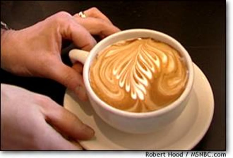 One of Schomer's trademark rosetta patterns atop the milk in a café latte.