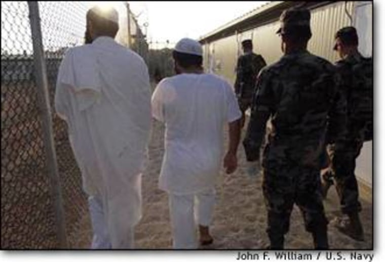 Two detainees are shown to new living quarters in a medium-security facility at Guantanamo Bay, Cuba, where close to 700 prisoners captured in Afghanistan are held.