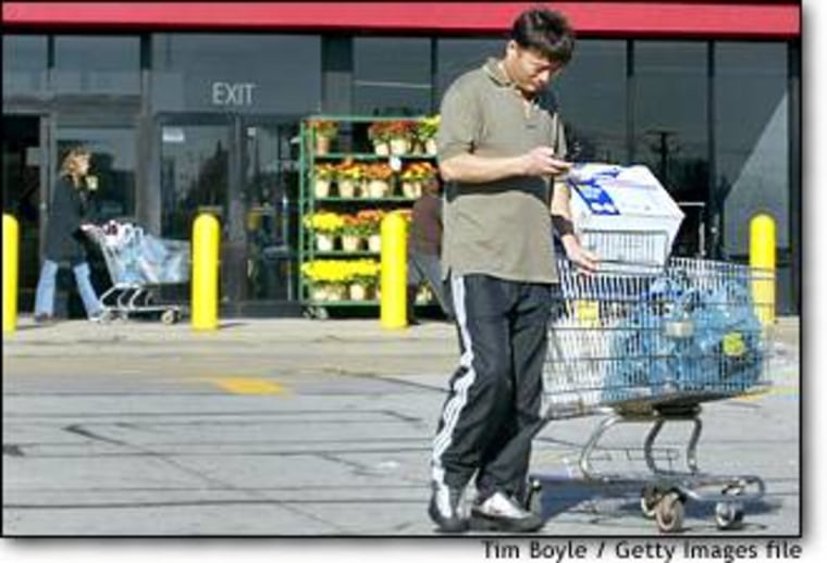 A shopper walks his purchases to the parking lot November 13, 2002 at a Wal-Mart store in Mount Prospect, Illinois. Wal-Mart Stores, is seen as a potential beneficiary of the government's $350 billion tax-cut package.