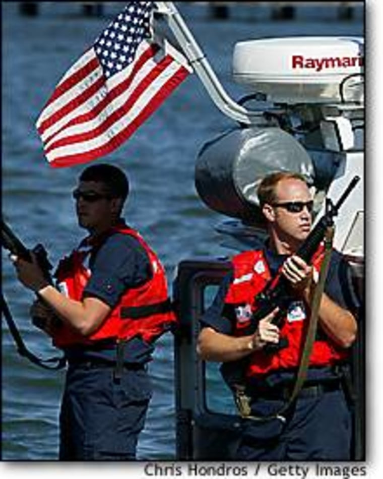 Coast Guard sailors brandish weapons during a drill in New York Harbor.
